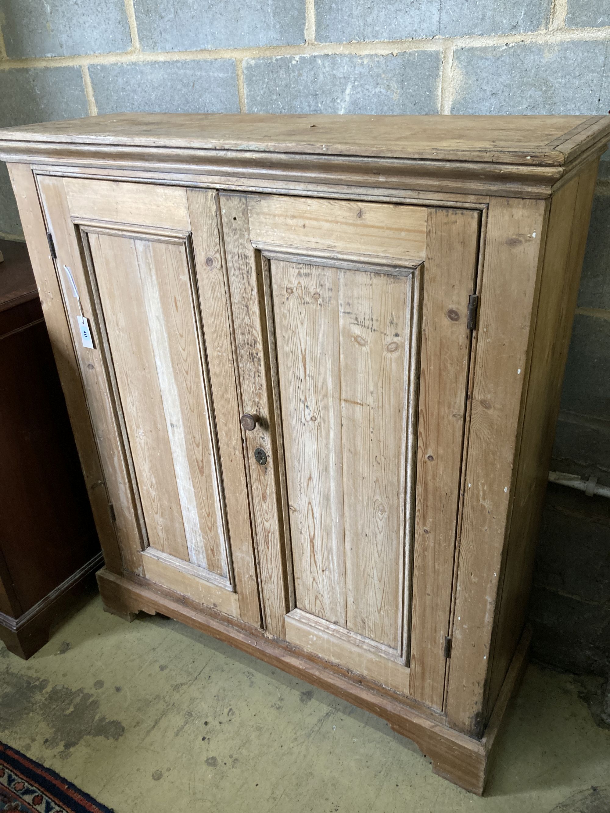 A Victorian pine two door cabinet, width 109cm, depth 37cm, height 127cm